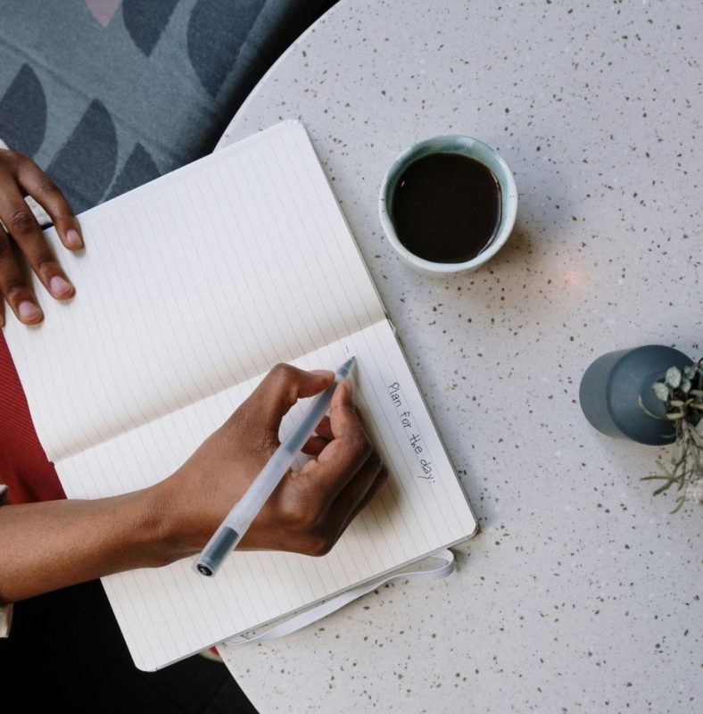 Person writing on a notebook